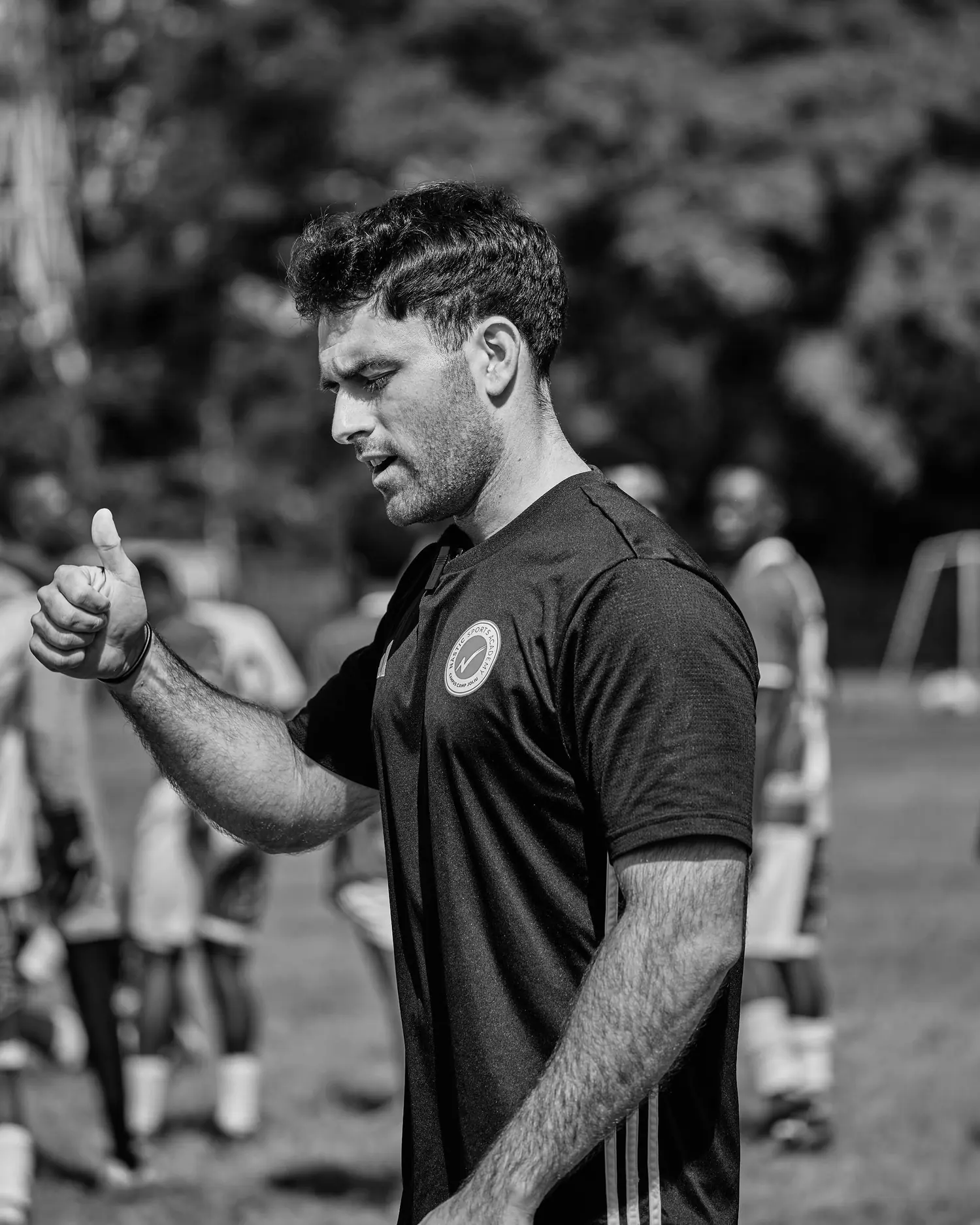 Jaime De Manuel Romero coaching on a training pitch, signalling approval