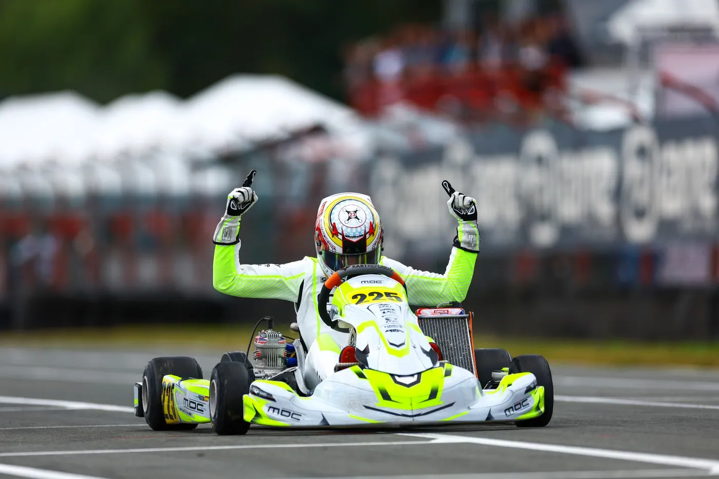 A DPF Group athlete celebrating in a kart on track